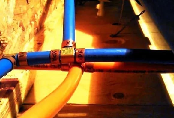 Blue and orange Kitec pipes with the brass fittings showing the XPA label
