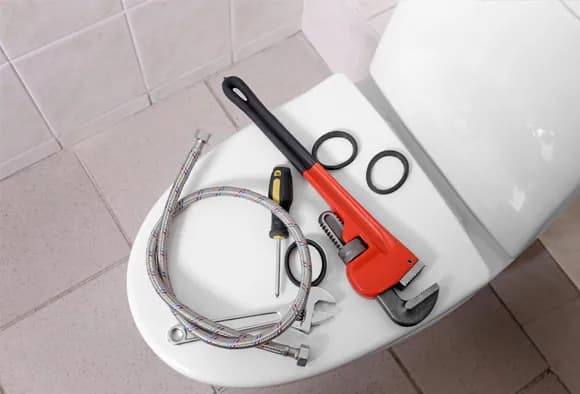 Tools on top of a toilet seat