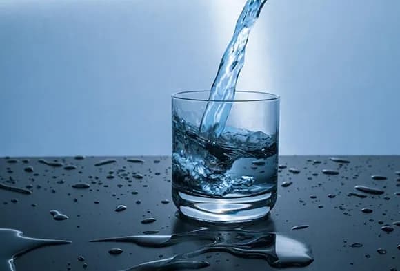 Close up of a glass being filled with water