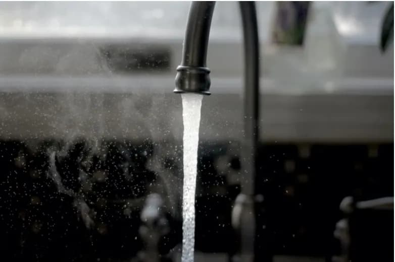 Water flowing from a kitchen faucet