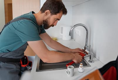 Kitchen sink plumbing being repaired