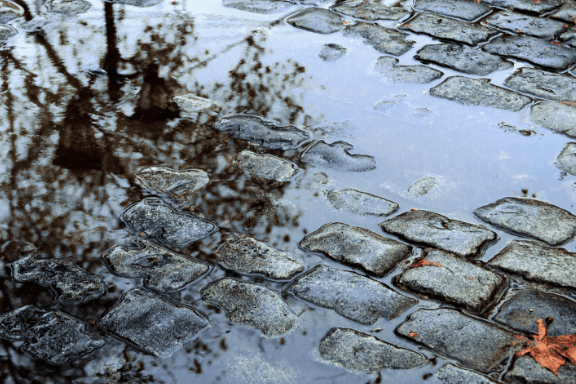 Close up of a puddle due to poor drainage