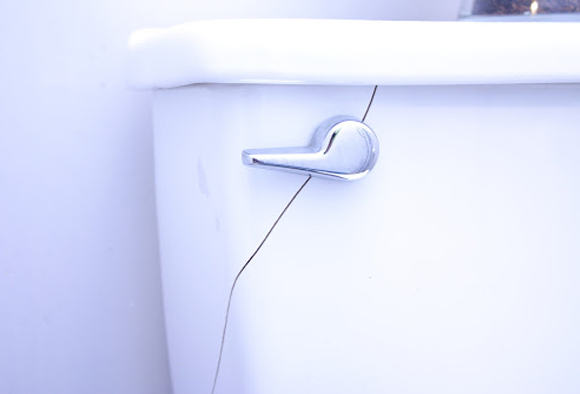 Close-up of a cracked toilet tank