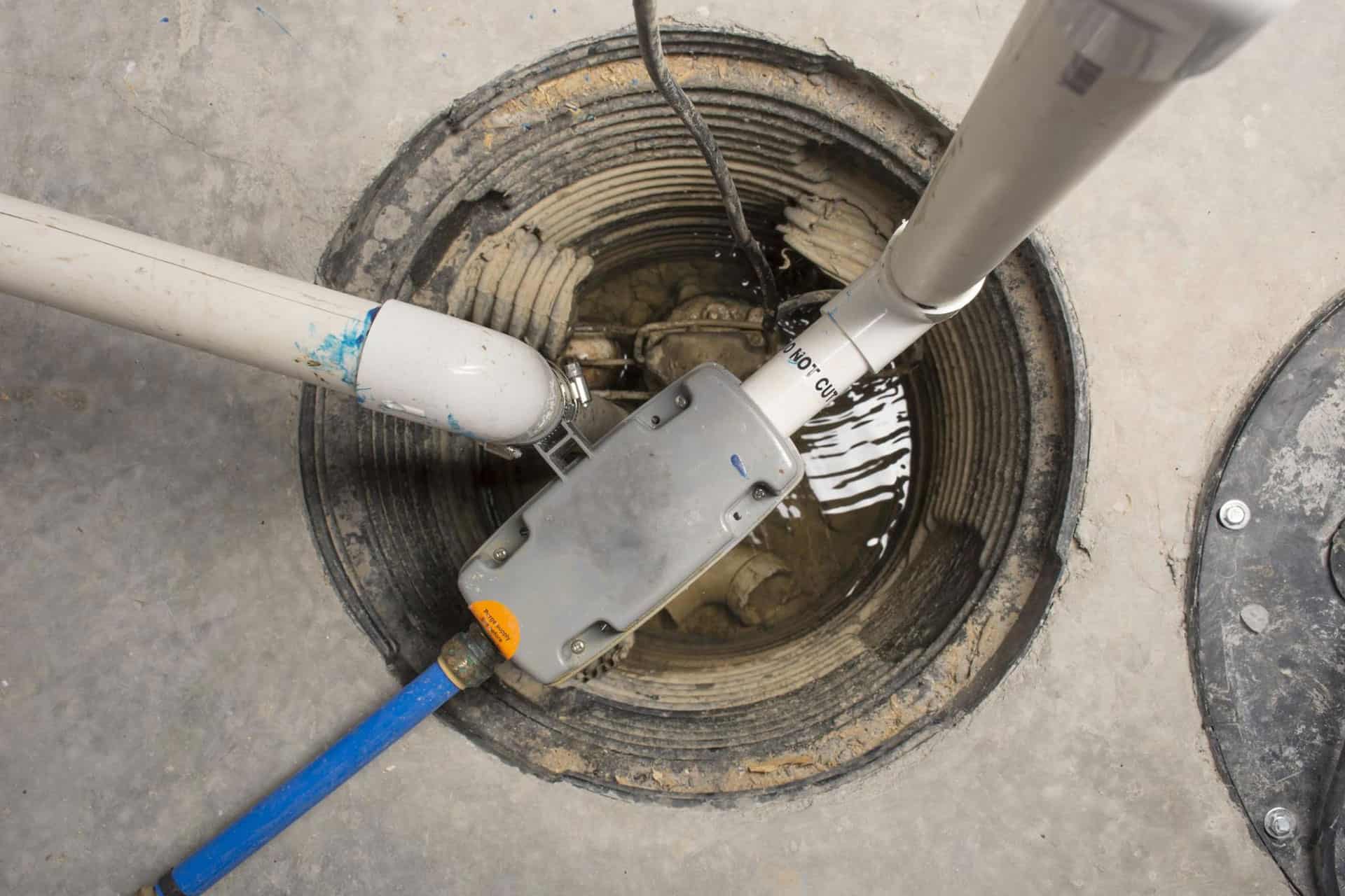 An overhead shot of a sump pump in a basement 