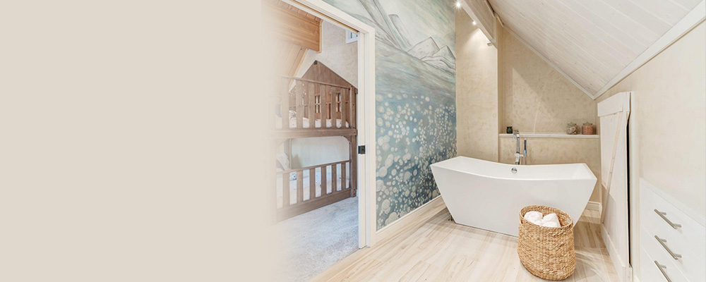 A bathroom with a mural and wood-like tiles, two bathroom tile trends for 2022