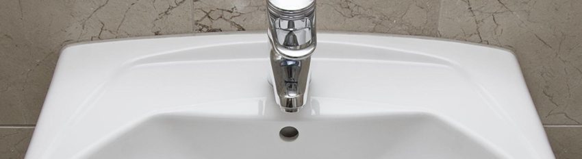 A porcelain sink that has hairline cracks needing porcelain sink repair