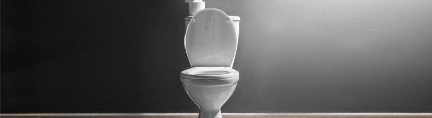 A porcelain toilet with dramatic lighting