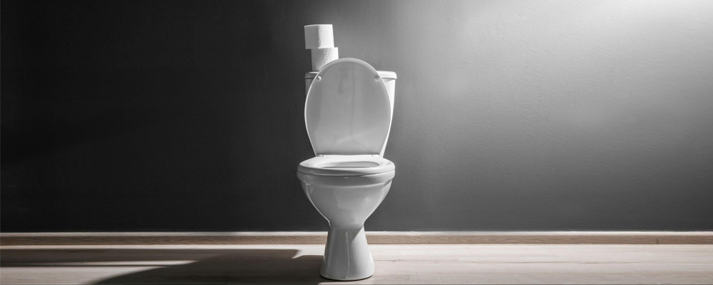 A porcelain toilet with dramatic lighting
