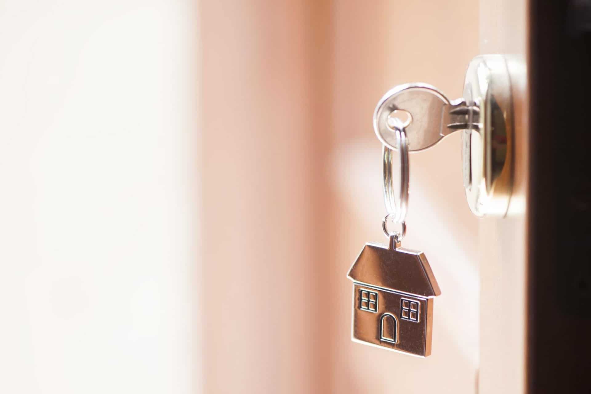  Close-up of a keychain holding the keys to a newly bought home that has undergone a drain camera inspection