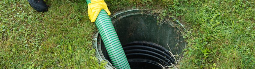 A plumber clearing a main sewer line clog