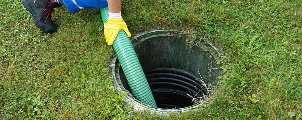 A plumber clearing a main sewer line clog