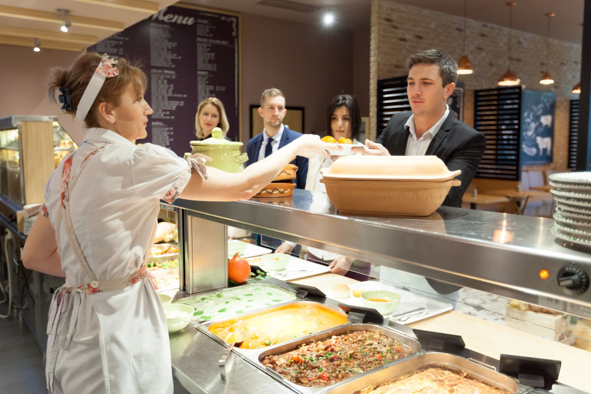 People standing in line at a cafeteria 