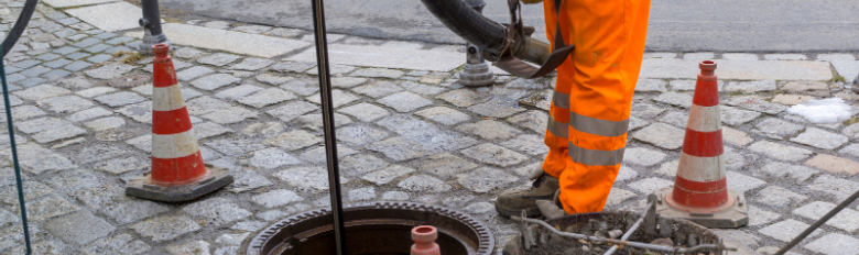 An expert carrying out industrial drain cleaning services