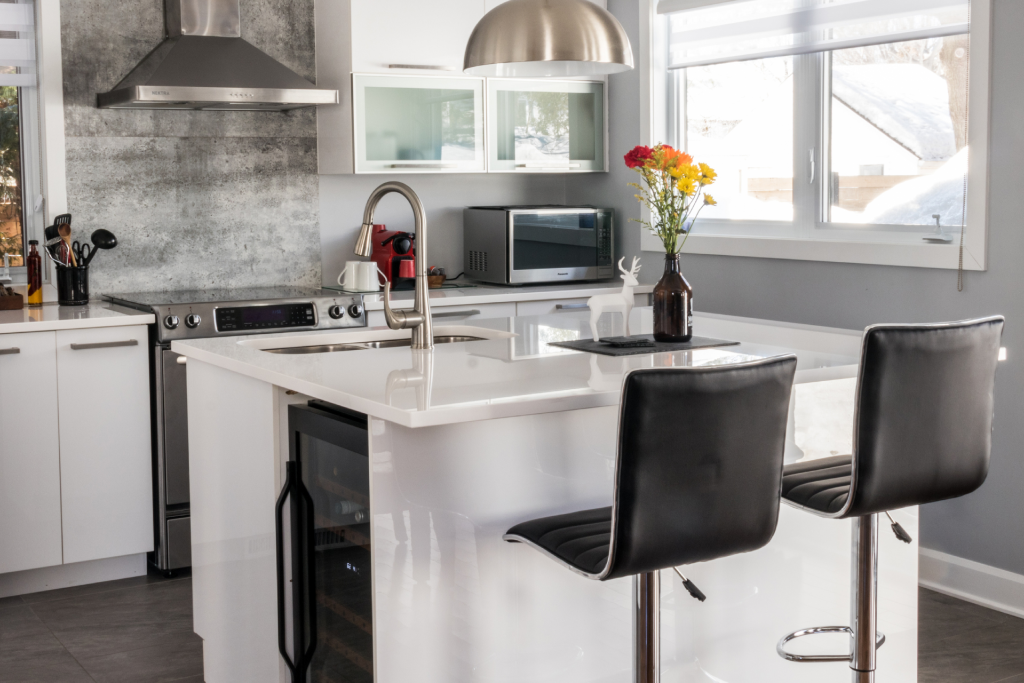 A small kitchen with an island and bar stools 