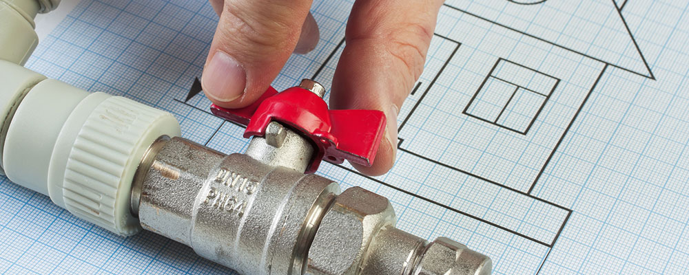 plumbing fixtures and a valve placed on a drawing of a house