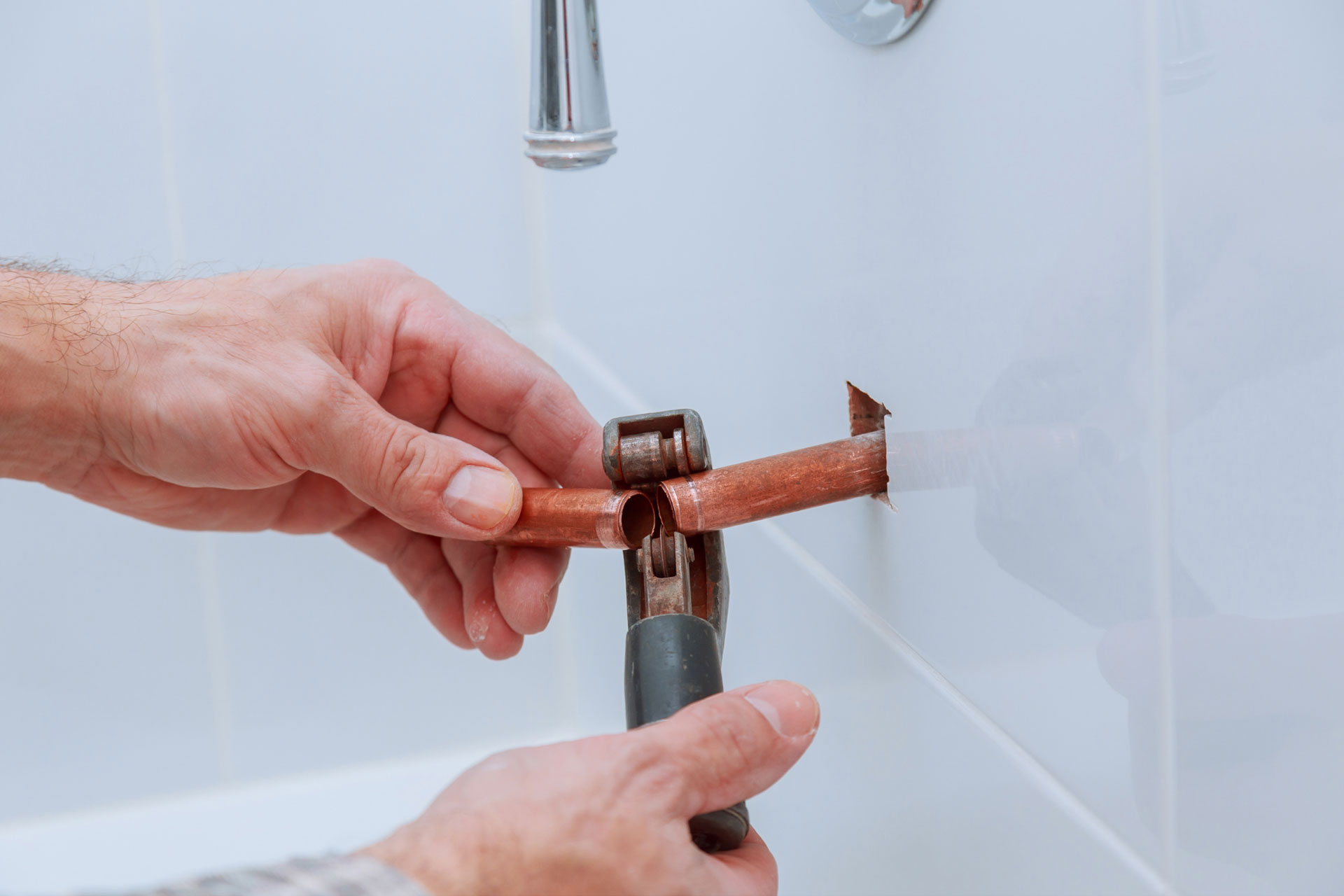  A plumber fixing a broken copper pipe 