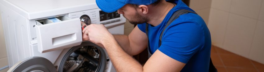 A professional plumber installing a washing machine