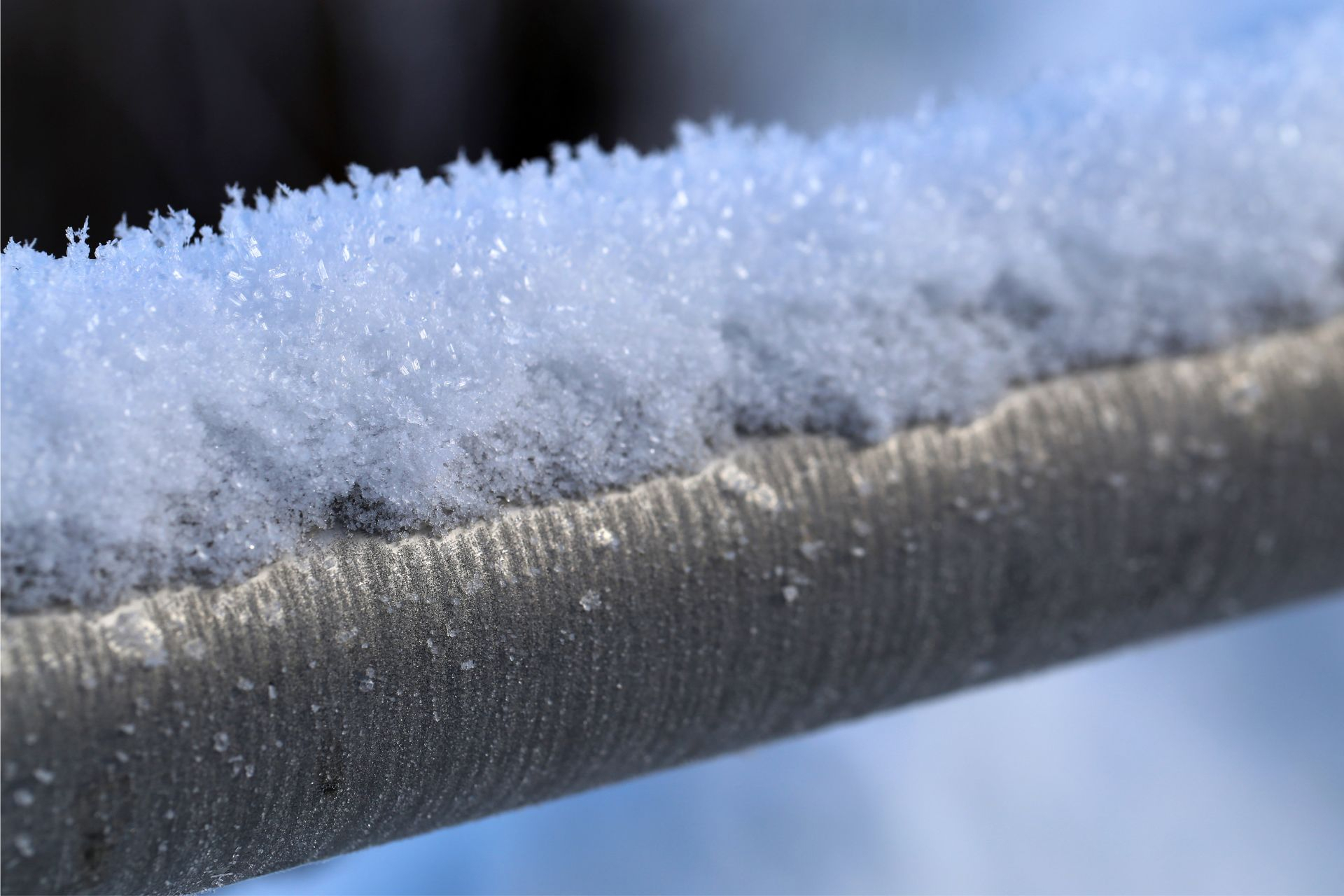 Frozen pipes covered in snow in the middle of winter 