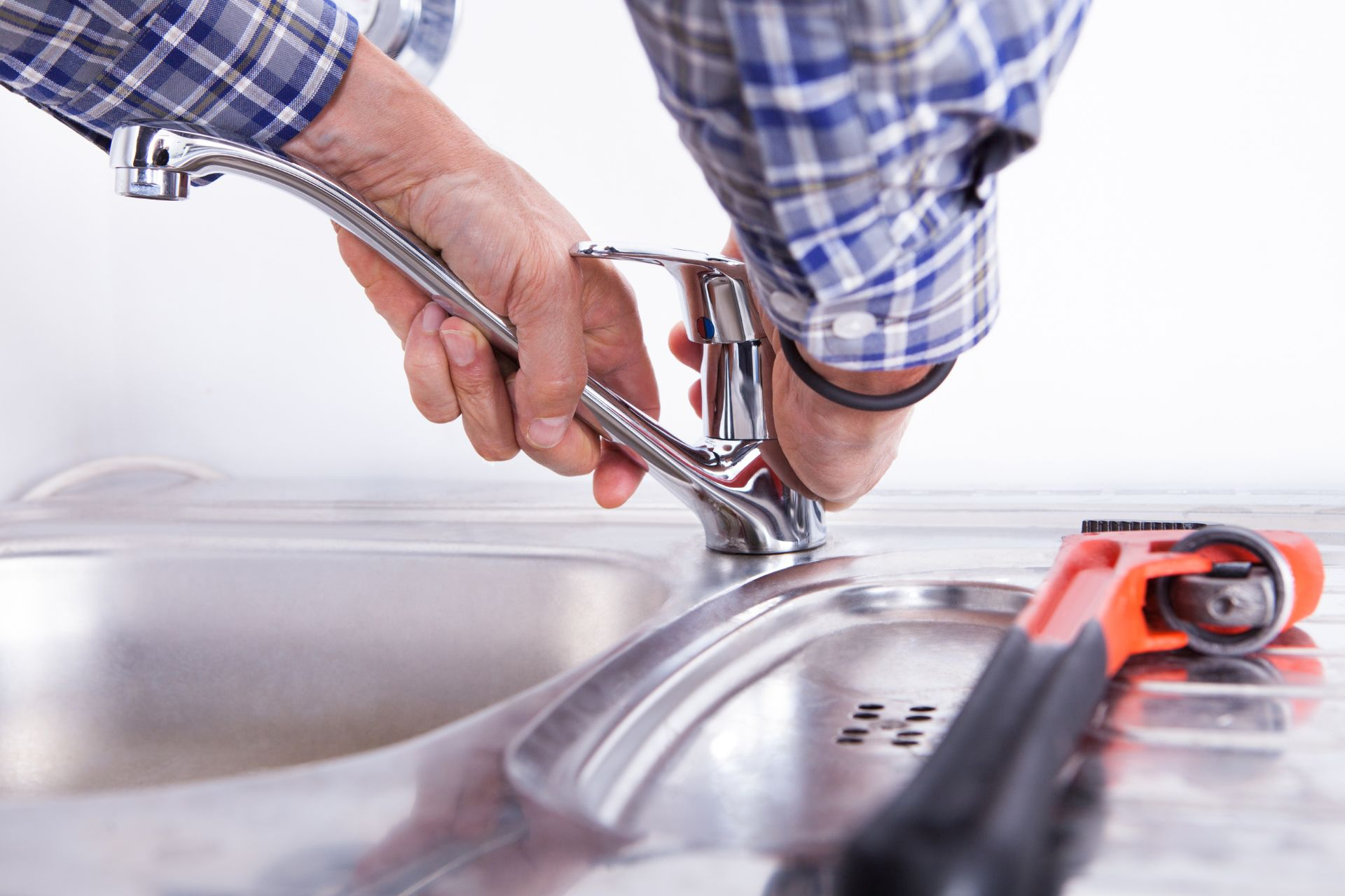  A plumber fixing a single-handle kitchen faucet 