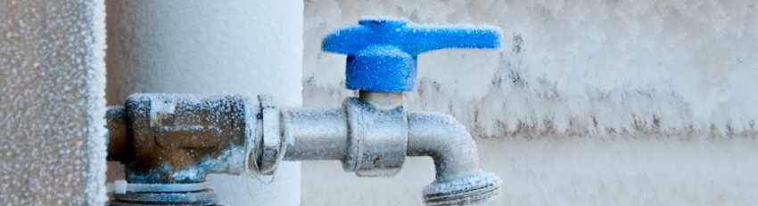 A frozen pipe covered in snow and ice