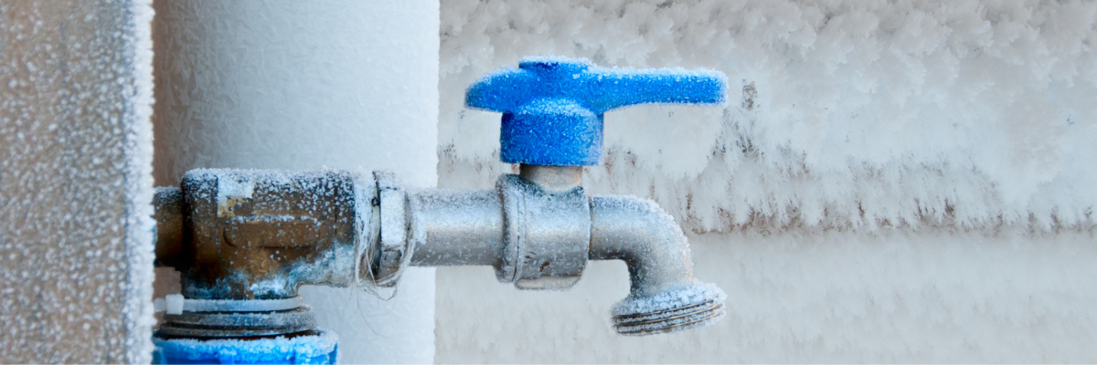 A frozen pipe covered in snow and ice
